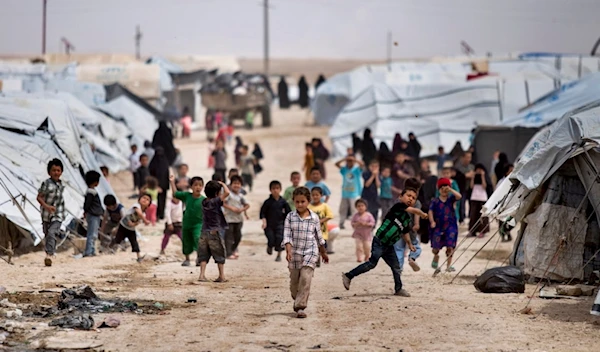 Children gather outside their tents at the al-Hol camp, which houses families of members of the Islamic State group, in Hasakeh province, Syria, on May 1, 2021 (AP)