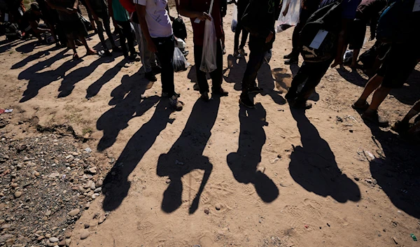 Migrants wait to be processed by the US Customs and Border Patrol after they crossed the Rio Grande and entered the US from Mexico, on Oct. 19, 2023, in Eagle Pass, Texas.(AP)