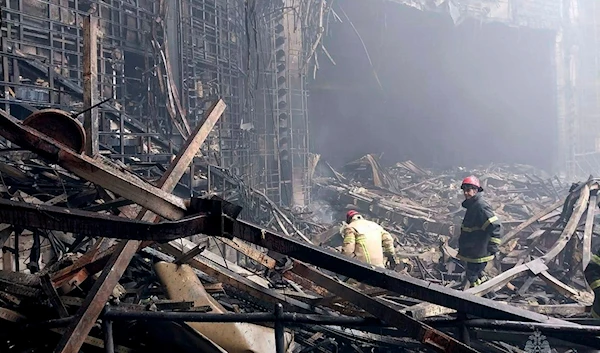 In this photo released by Russian Emergency Ministry Press Service on March 23, 2024, firefighters work in the burned concert hall after an attack on the building of the Crocus City Hall on the western edge of Moscow, Russia (AP)