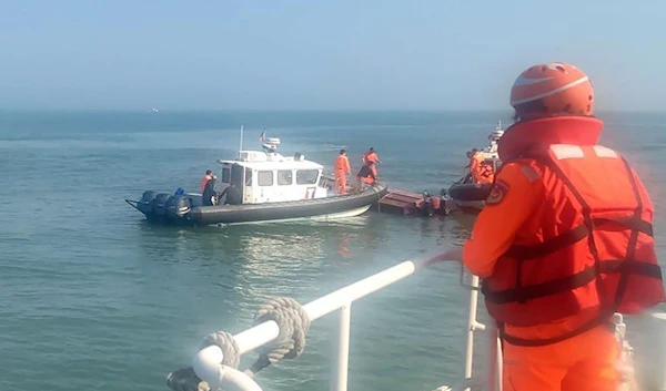 In this photo distributed by the Taiwanese Coast Guard, guards inspect a vessel that capsized during a chase off the coast of the Kinmen Archipelago in Taiwan,, February 14, 2024. (AP)