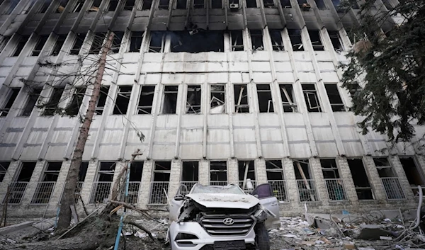 A damaged car is seen in at the site of a Russian attack in Kharkiv, Ukraine, Wednesday, March 20, 2024. (AP Photo/Andrii Marienko)