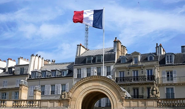 The French flag float at the presidential Elysee palace during the weekly cabinet meeting, Wednesday, April 20, 2022 in Paris. (AP)