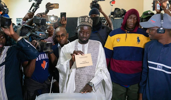 Senegalese opposition candidate Bassirou Diomaye Faye casts his ballot for the presidential elections, in Ndiaganiao, Senegal, March 24, 2024. (AP)