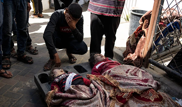 Palestinians mourn relatives killed in the Israeli bombardment of the Gaza Strip at a hospital morgue in Rafah, Wednesday, March 20, 2024. (AP)