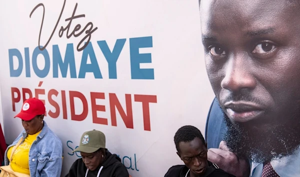 Supporters of presidential candidate Bassirou Diomaye Faye gather outside his campaign headquarters after preliminary results put him as the expected winner, in Dakar, Senegal, Monday, March 25, 2024. (AP)