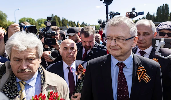 Russia's Ambassador to Poland Sergey Andreev, right, speaks to reporters in front of a memorial site to Red Army soldiers in Warsaw, Poland, Tuesday May 9, 2023. (AP)