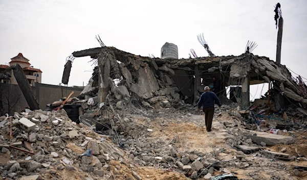 Palestinians look at a house destroyed in an Israeli strike in Rafah, Gaza Strip on Tuesday, March 26, 2024 (AP Photo/Fatima Shbair)