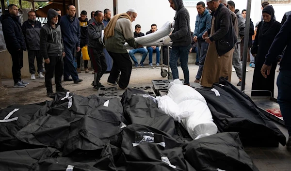 Palestinians mourn relatives killed in the Israeli occupation's bombardment of the Gaza Strip at a hospital morgue in Rafah, Palestine, Tuesday, March 26, 2024. (AP)