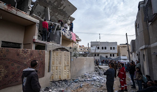 Palestinians search for bodies of their martyrs at a house hit by an Israeli strike in Rafah, Gaza Strip on Wednesday, March 27, 2024. (AP)