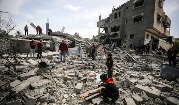 Palestinians inspect the damage to a residential building for the Moussa family after an Israeli airstrike in the Maghazi refugee camp, central Gaza Strip, Friday, March 29, 2024. (AP)