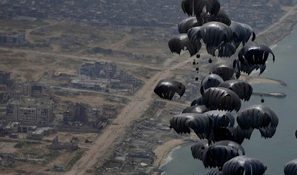 Containers of humanitarian aid is airdropped to Palestinians in the Gaza Strip from a U.S. C-17 Air Force plane, Friday, March 29, 2024. (AP Photo/Hussein Malla)