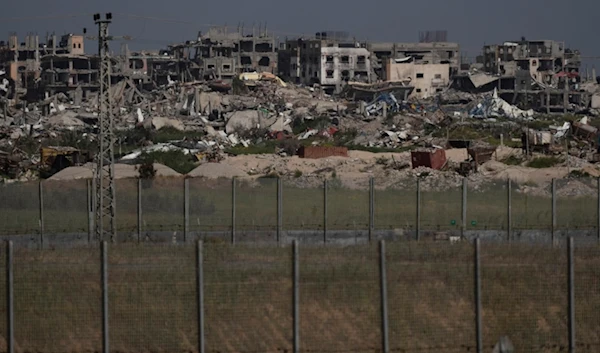 Destroyed buildings stand in the Gaza Strip as seen from southern Palestine, Thursday, March 28, 2024. (AP Photo/Leo Correa)