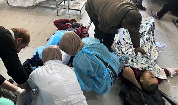 Palestinians wounded in an Israeli strike while waiting for humanitarian aid on the beach in Gaza City are treated in al-Shifa Hospital in Gaza City, February 29, 2024 (AP)