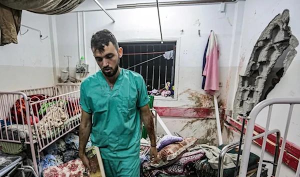 A Palestinian nurse inspects the damage in a room at Nasser Hospital in Khan Younis in the southern Gaza Strip on Dec. 17, 2023, following Israeli bombardment. (AFP via Getty Images)