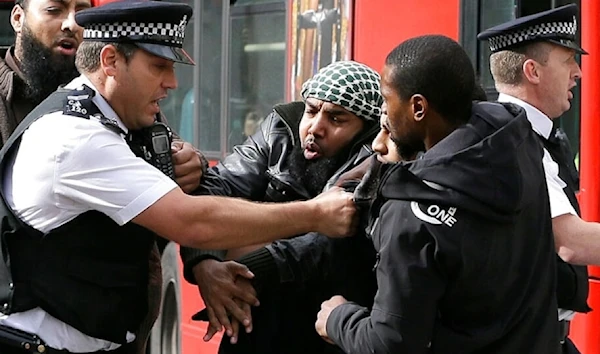 Demonstrators clash with police officers outside The Royal Courts of Justice in London Friday, Oct.5, 2012. (AP)