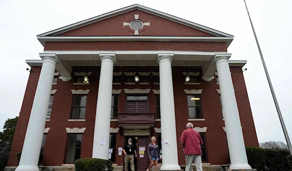 Voters enter and exit a polling facility at the Seale Courthouse in Russell County during a primary election, Tuesday, March 5, 2024, in Seale, Alabama (AP)