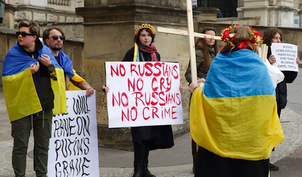 Demonstrators protest in front of Hofburg Palace during an OSCE Parliamentary Assembly, in Vienna, Austria, Thursday, Feb. 23, 2023. (AP)