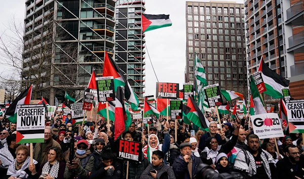 Demonstrators hold flags and placards as they attend a march in support of the Palestinian people in Gaza, in London, Saturday, March 9, 2024.(AP)