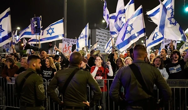 Israeli Police assault settlers during an anti-government protest on July 24, 2023. (AP)