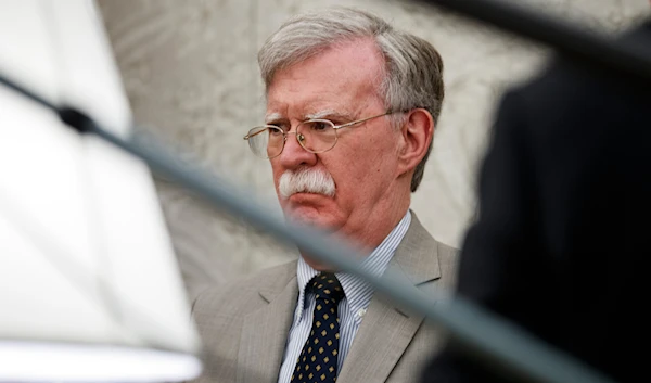 National security adviser John Bolton listens as President Donald Trump speaks during a meeting with Romanian President Klaus Iohannis in the Oval Office of the White House, on August 20, 2019, in Washington. (AP)