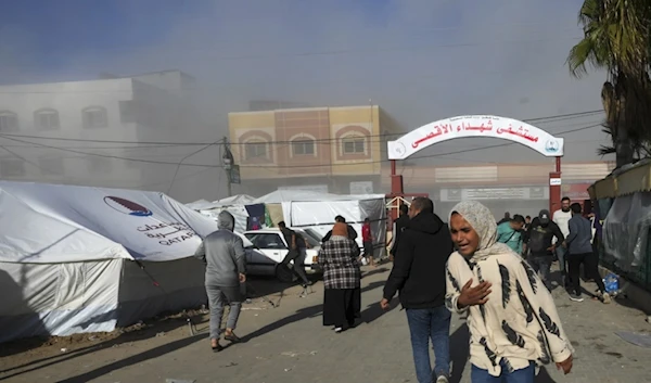 Palestinians run after an Israeli strike hit the vicinity of al-aqsa Hospital on January 10, 2023. (AP)