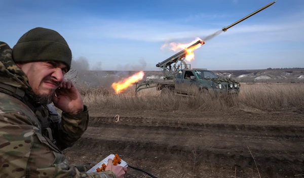 A Ukrainian officer from The 56th Separate Motorized Infantry Mariupol Brigade fires a multiple-launch rocket system based on a pickup truck near Bakhmut, Donetsk, Ukraine, March 5, 2024 (AP)