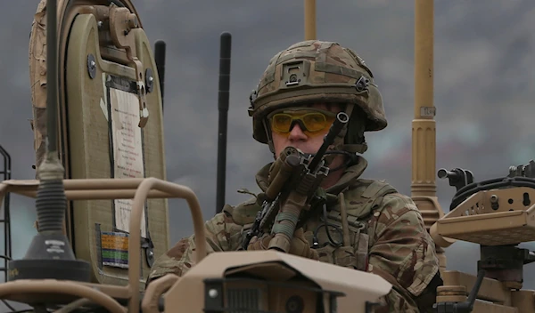 A British soldier with NATO-led Resolute Support Mission forces arrives at the site of an attack in Kabul, Afghanistan, Wednesday, March 25, 2020 (AP)