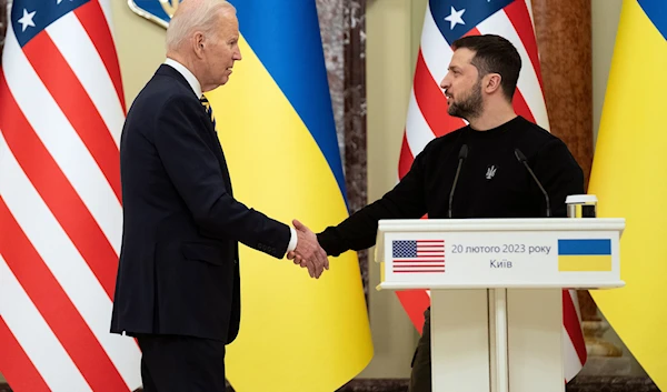 US President Joe Biden, left, shakes hands with Ukrainian President Volodymyr Zelenskyy after they both delivered statements at Mariinsky Palace during an unannounced visit, in Kyiv, Ukraine, Monday, Feb. 20, 2023.(AP)