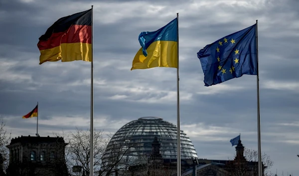 A German, Ukrainian and European flag wave in front of the Reichstag building in Berlin, Germany, Friday, Feb.16, 2024. (AP)