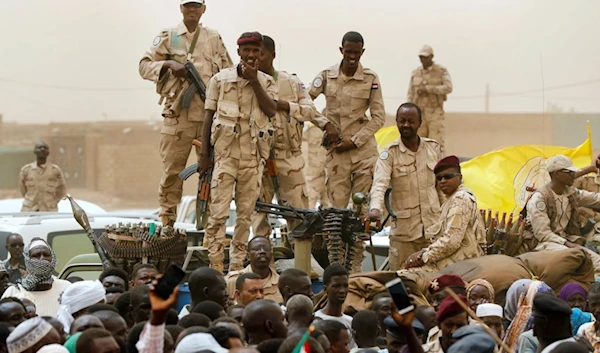 Sudanese soldiers from the Rapid Support Forces unit stand on their vehicle during a military-backed rally, in Mayo district, south of Khartoum, Sudan, Saturday, June 29, 2019. (AP)