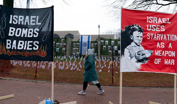 Banners are seen during a pro-Palestinian demonstration outside of the Israeli Embassy in Washington, Saturday, March 2, 2024. (AP)