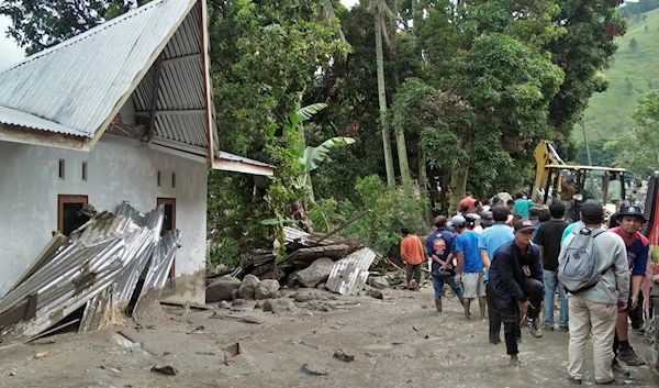 Rescue workers and residents inspect the damage caused by a landslide in Simangulampe village, North Sumatra, Indonesia, Saturday, Dec. 2, 2023.(AP)