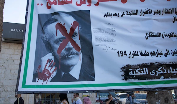 A Billboard with a defaced picture of British Foreign Secretary Arthur Balfour reading, 'we will not forget, we will not forgive,' in the street in Ramallah, occupied Palestine Nov. 4, 2021 (AP)