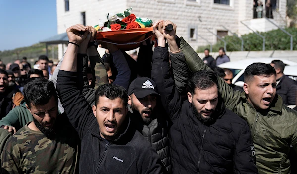 Palestinians carry the body of martyr Amr al-Najjar, 11, during his funeral in the West Bank village of Burin, near Nablus, Tuesday, March 5, 2024(AP).