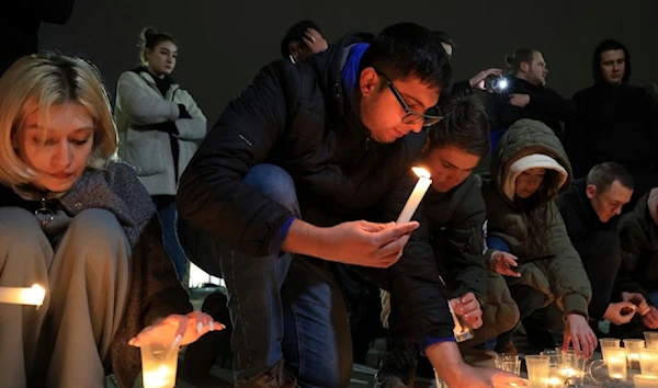 People light candles in memory of the victims of the terrorist attack in Moscow in Crimea, Friday March 22, 2024. (AP)