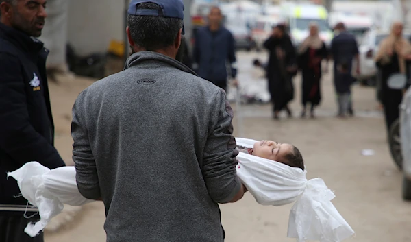 Mohsen Muammar carries the body of his son Muhammad, 3, killed in the Israeli bombardment of the Gaza Strip, on his way to bury him in Rafah, southern Gaza Strip, Friday, March 29, 2024.(AP)