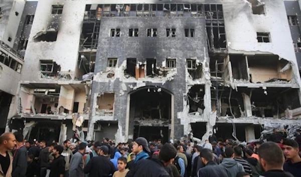 Palestinians inspect the damage outside Gaza s Al-Shifa hospital after the Israeli military withdrew from the complex housing the hospital on April 1, 2024.AFP