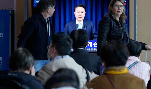 People watch a TV screen showing the live broadcast of South Korean President Yoon Suk Yeol’s addressing the nation at the Seoul Railway Station in Seoul, South Korea, Monday, April 1, 2024. (AP)