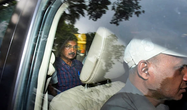 Arvind Kejriwal, leader of the Aam Admi Party, or Common Man's Party, left, leaves in a car after attending a hearing at a court, in New Delhi, India, Thursday, March 28, 2024. (AP)