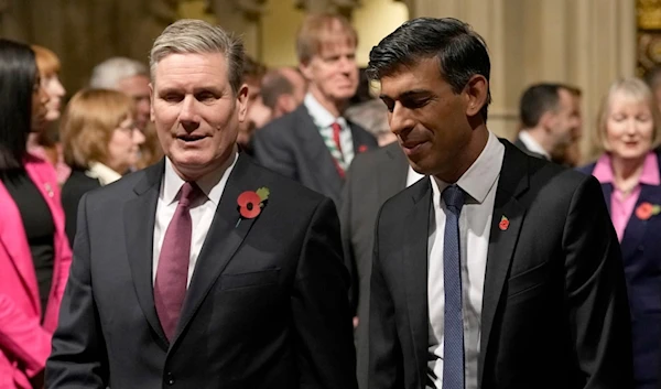 Britain's Prime Minister Rishi Sunak, right, and Labour Party leader Keir Starmer pass through the Peer's Lobby to attend the State Opening of Parliament at the Palace of Westminster in London, Tuesday, Nov. 7, 2023 (AP)