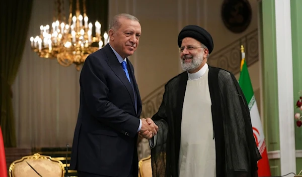 Turkish President Recep Tayyip Erdogan, left, and his Iranian counterpart Ebrahim Raisi shake hands at the conclusion of their joint press briefing at the Saadabad Palace, in Tehran, Iran, Tuesday, July 19, 2022 (AP Photo/Vahid Salemi)