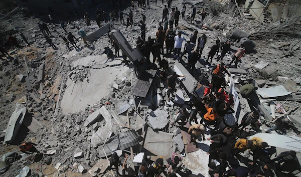 Palestinians look at a residential building destroyed in an Israeli strike in Rafah, Gaza Strip, Tuesday, March 20, 2024. (AP)