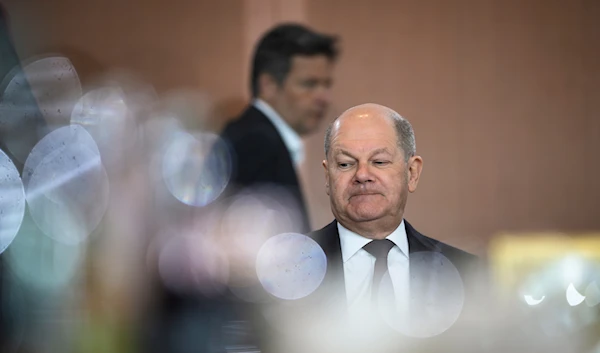 German Economy and Climate Minister Robert Habeck walks behind German Chancellor Olaf Scholz during the weekly cabinet meeting at the chancellery in Berlin, Germany, Wednesday, April 10, 2024. (AP)