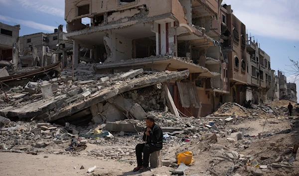 Palestinians walk through the destruction in the wake of an Israeli air and ground offensive in Khan Younis, southern Gaza Strip, Monday, April 8, 2024. (AP)