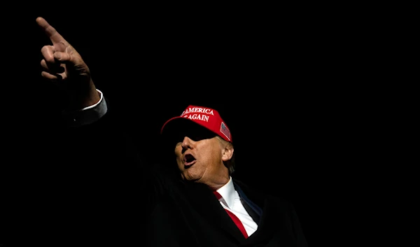 Former US President Donald Trump greets attendees during a campaign event in Schnecksville, Pa., on Saturday, April 13, 2024. (AP)