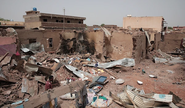 A man walks by a house hit in fighting in Khartoum, Sudan, Tuesday, April 25, 2023. (AP)