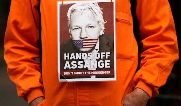 A Protester stands in front of the Ecuadorian Embassy in London, Thursday, April 11, 2024, where Wikileaks founder Julian Assange was arrested five years ago (AP)