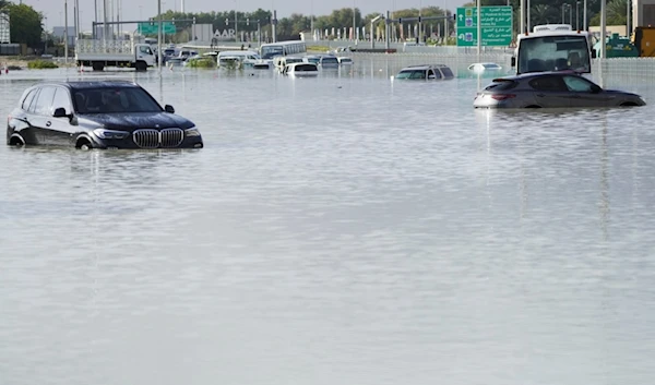 Vehicles sit abandoned in floodwater covering a major road in Dubai, United Arab Emirates, Wednesday, April 17, 2024 (AP)