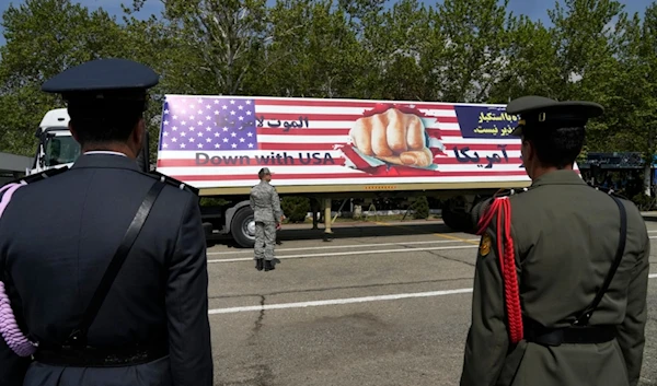 An anti-U.S. banner is carried on a truck during Army Day parade at a military base in northern Tehran, Iran, Wednesday, April 17, 2024 (AP)