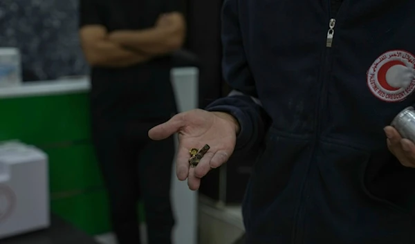 Bashar al-Qaryoute, a Palestinian Red Crescent medic, displays bullet casings that he says he has collected from attacks by Israeli settlers and soldiers on his ambulance in the village of Qaryout in the northern West Bank, Sunday, Nov. 12, 2023. (AP)